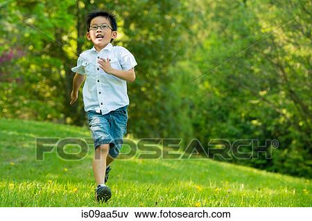 Stock Photo - Boy running on grass. Fotosearch