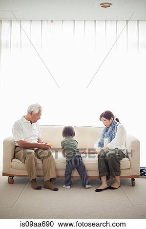 Boy with his mother and grandfather on sofa View Large Photo Image Stock Image - Boy with his mother and grandfather on sofa. Fotosearch