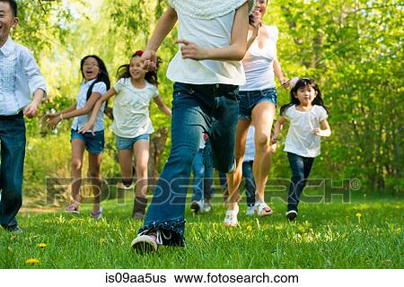 Boys and girls running in park View Large Photo Image Stock Photograph - Boys and girls running in park. Fotosearch
