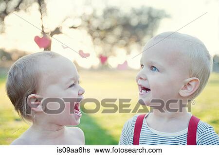 Brother and sister laughing outdoors View Large Photo Image Stock Photograph - Brother and sister laughing outdoors. Fotosearch
