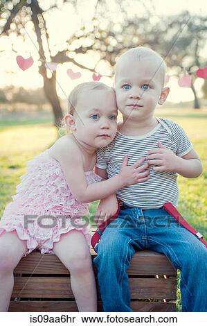 Brother and sister sitting outdoors View Large Photo Image Stock Photography - Brother and sister sitting outdoors. Fotosearch
