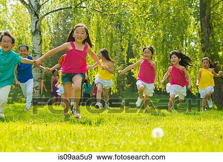 Stock Photo - Children running on grass. Fotosearch