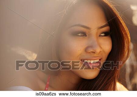 Close up portrait of smiling young woman View Large Photo Image Stock Photograph - Close up portrait of smiling young woman. Fotosearch