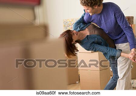 Couple dancing together whilst moving house View Large Photo Image Stock Image - Couple dancing together whilst moving house. Fotosearch