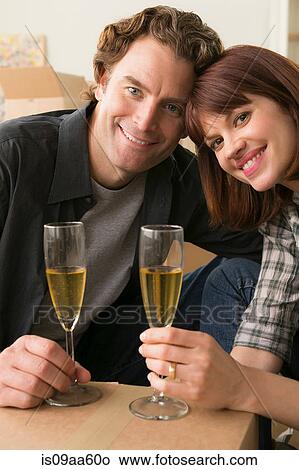 Couple having champagne break whilst moving View Large Photo Image Picture - Couple having champagne break whilst moving. Fotosearch