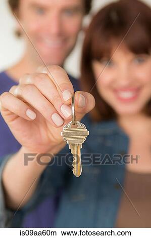 Picture - Couple holding new door key. Fotosearch