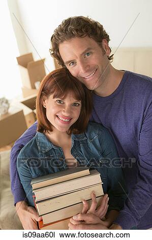 Couple holding pile of books View Large Photo Image Stock Image - Couple holding pile of books. Fotosearch