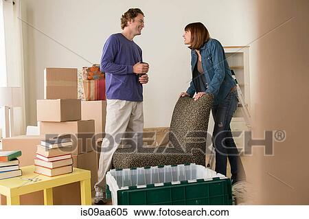 Couple in sitting room during house move View Large Photo Image Stock Photography - Couple in sitting room during house move. Fotosearch
