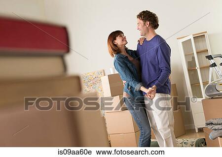 Couple sharing dance whilst moving house View Large Photo Image Stock Image - Couple sharing dance whilst moving house. Fotosearch