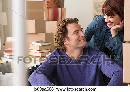 Couple surrounded by cardboard boxes View Large Photo Image Stock Photograph - Couple surrounded by cardboard boxes. Fotosearch