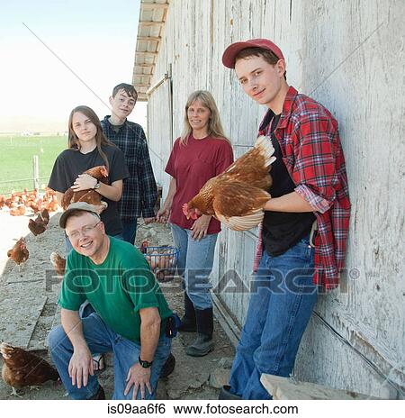 Stock Photograph - Farming family holding chickens, portrait. Fotosearch