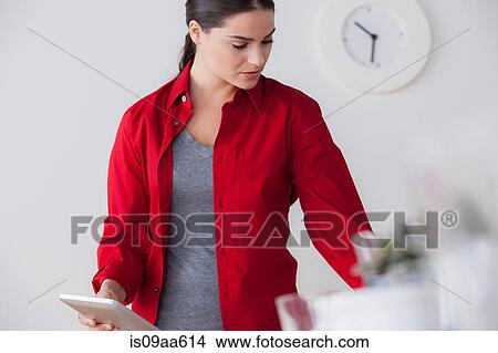 Picture - Female office worker holding digital tablet. Fotosearch