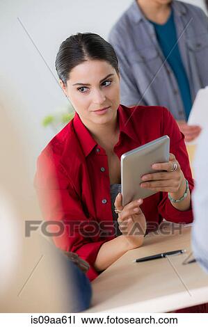 Female office worker holding digital tablet View Large Photo Image Stock Image - Female office worker holding digital tablet. Fotosearch