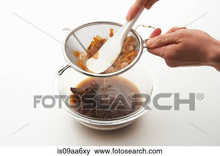 Female straining vegetable stock from sieve View Large Photo Image Stock Photo - Female straining vegetable stock from sieve. Fotosearch