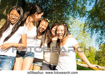 Five girls wearing white t-shirts laughing View Large Photo Image Picture - Five girls wearing white t-shirts laughing. Fotosearch
