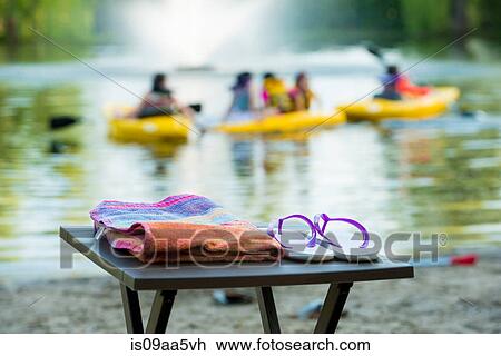 Flip flops and towel on table by lake View Large Photo Image Stock Image - Flip flops and towel on table by lake. Fotosearch
