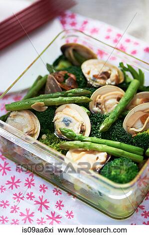 Stock Image - Fresh Japanese cuisine with asparagus, seafood and broccoli. Fotosearch