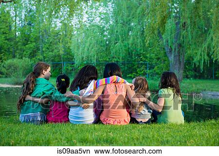 Friends sitting by lake View Large Photo Image Picture - Friends sitting by lake. Fotosearch