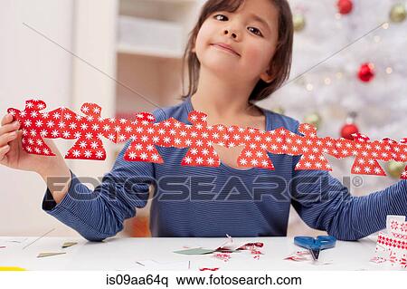 Stock Photography - Girl holding Christmas decoration, portrait. Fotosearch