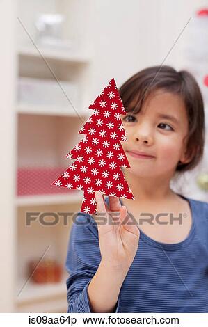 Stock Photography - Girl holding Christmas tree decoration. Fotosearch