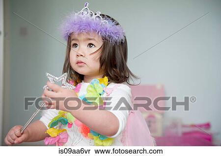 Stock Photography - Girl in fairy costume holding magic wand. Fotosearch