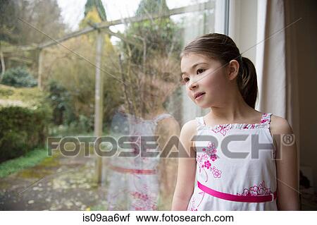 Stock Image - Girl looking out of window. Fotosearch