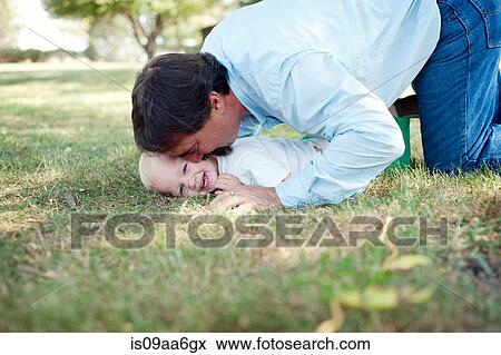 Grandfather having fun with grandson in park View Large Photo Image Stock Photo - Grandfather having fun with grandson in park. Fotosearch