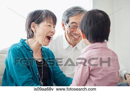 Stock Photo - Grandparents with grandson laughing. Fotosearch
