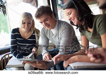 Stock Image - Group of people studying together in cafe. Fotosearch