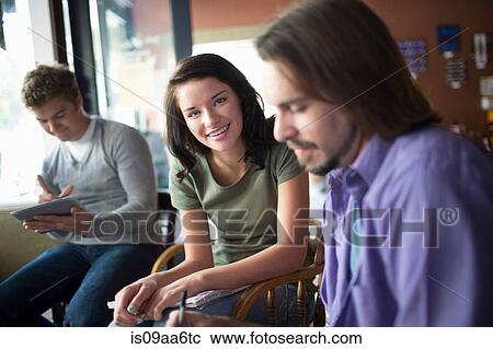 Group of people studying together in coffee shop View Large Photo Image Stock Image - Group of people studying together in coffee shop. Fotosearch