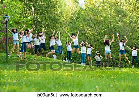 Large group of children jumping in park View Large Photo Image Stock Photograph - Large group of children jumping in park. Fotosearch