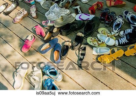 Large group of shoes on wooden planks View Large Photo Image Stock Image - Large group of shoes on wooden planks. Fotosearch