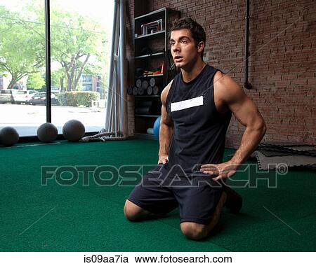 Male bodybuilder taking a break in gym View Large Photo Image Stock Image - Male bodybuilder taking a break in gym. Fotosearch