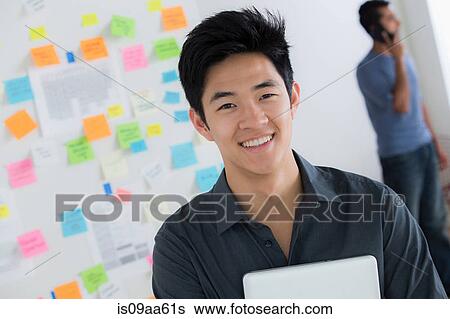Male office worker holding digital tablet View Large Photo Image Stock Photograph - Male office worker holding digital tablet. Fotosearch