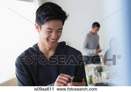 Male office worker texting on mobile phone View Large Photo Image Stock Image - Male office worker texting on mobile phone. Fotosearch