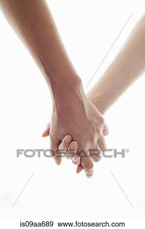 Stock Photo - Man and woman holding hands, portrait. Fotosearch