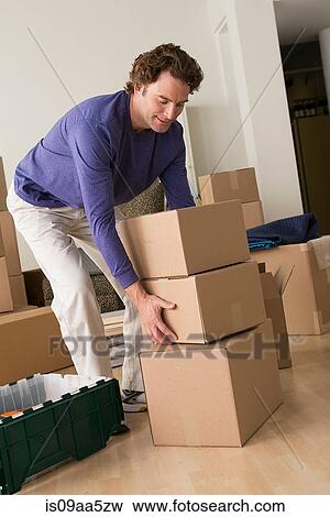 Mature man moving cardboard boxes View Large Photo Image Stock Photo - Mature man moving cardboard boxes. Fotosearch