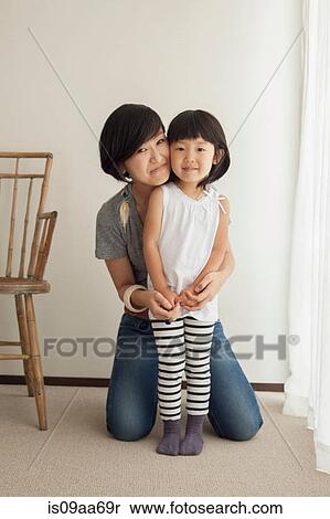 Stock Photography - Mother and daughter smiling, portrait. Fotosearch