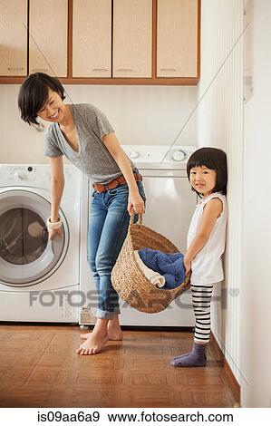 Mother and daughter with laundry basket View Large Photo Image Stock Photo - Mother and daughter with laundry basket. Fotosearch