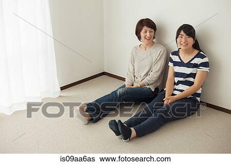 Mother and teenage daughter sitting on floor, portrait View Large Photo Image Stock Photograph - Mother and teenage daughter sitting on floor, portrait. Fotosearch