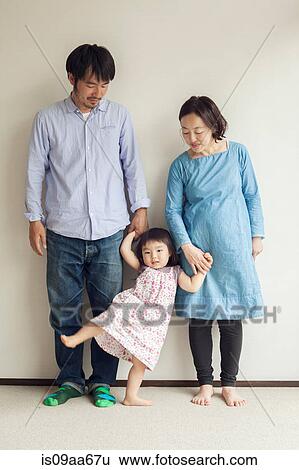 Parents holding daughter's hands, portrait View Large Photo Image Stock Photograph - Parents holding daughter's hands, portrait. Fotosearch
