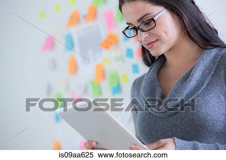 Portrait of female office worker holding file View Large Photo Image Stock Photography - Portrait of female office worker holding file. Fotosearch