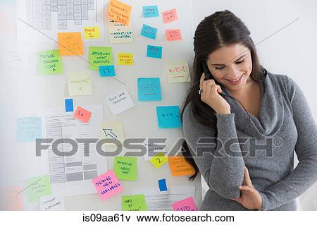 Portrait of female office worker using mobile View Large Photo Image Stock Photo - Portrait of female office worker using mobile. Fotosearch