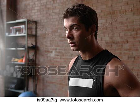 Stock Image - Portrait of male bodybuilder in gym. Fotosearch
