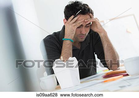 Stock Photo - Portrait of male office worker with hands on head. Fotosearch