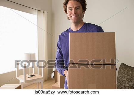 Stock Photo - Portrait of mature man holding cardboard boxes. Fotosearch
