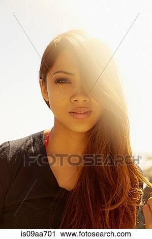 Portrait of smiling young woman at coast View Large Photo Image Stock Image - Portrait of smiling young woman at coast. Fotosearch