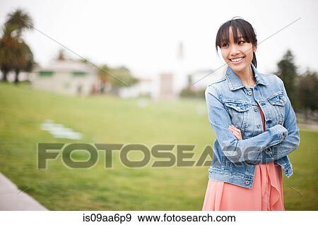 Stock Photo - Portrait of young girl in park. Fotosearch