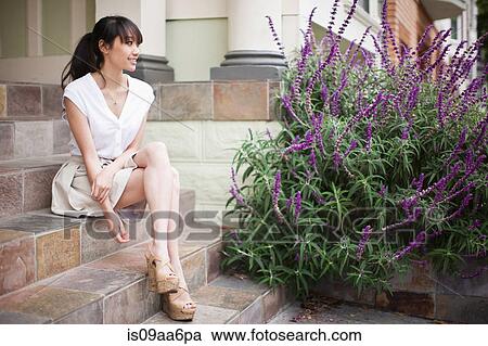 Portrait of young girl sitting on steps at home View Large Photo Image Stock Image - Portrait of young girl sitting on steps at home. Fotosearch