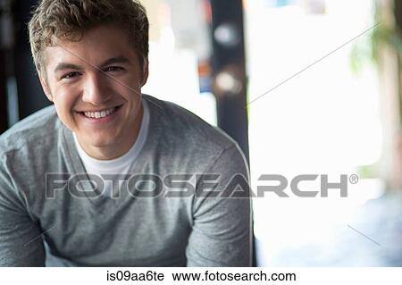 Portrait of young man in cafe View Large Photo Image Stock Image - Portrait of young man in cafe. Fotosearch